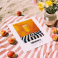 Mimosa – on Striped Tablecloth, French Cocktail Print, unframed on coastal sand