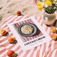Cottage – on Striped Tablecloth, Cheese Wall Decor, unframed on coastal sand
