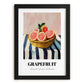 Grapefruit – on Striped Tablecloth, Fruit Still Life, in sleek black frame