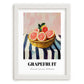 Grapefruit – on Striped Tablecloth, Fruit Still Life, placed in minimal white frame