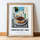 Chocolate Cake – White village Street Café Scene, American Dessert Print, in wooden frame leaning on the floor